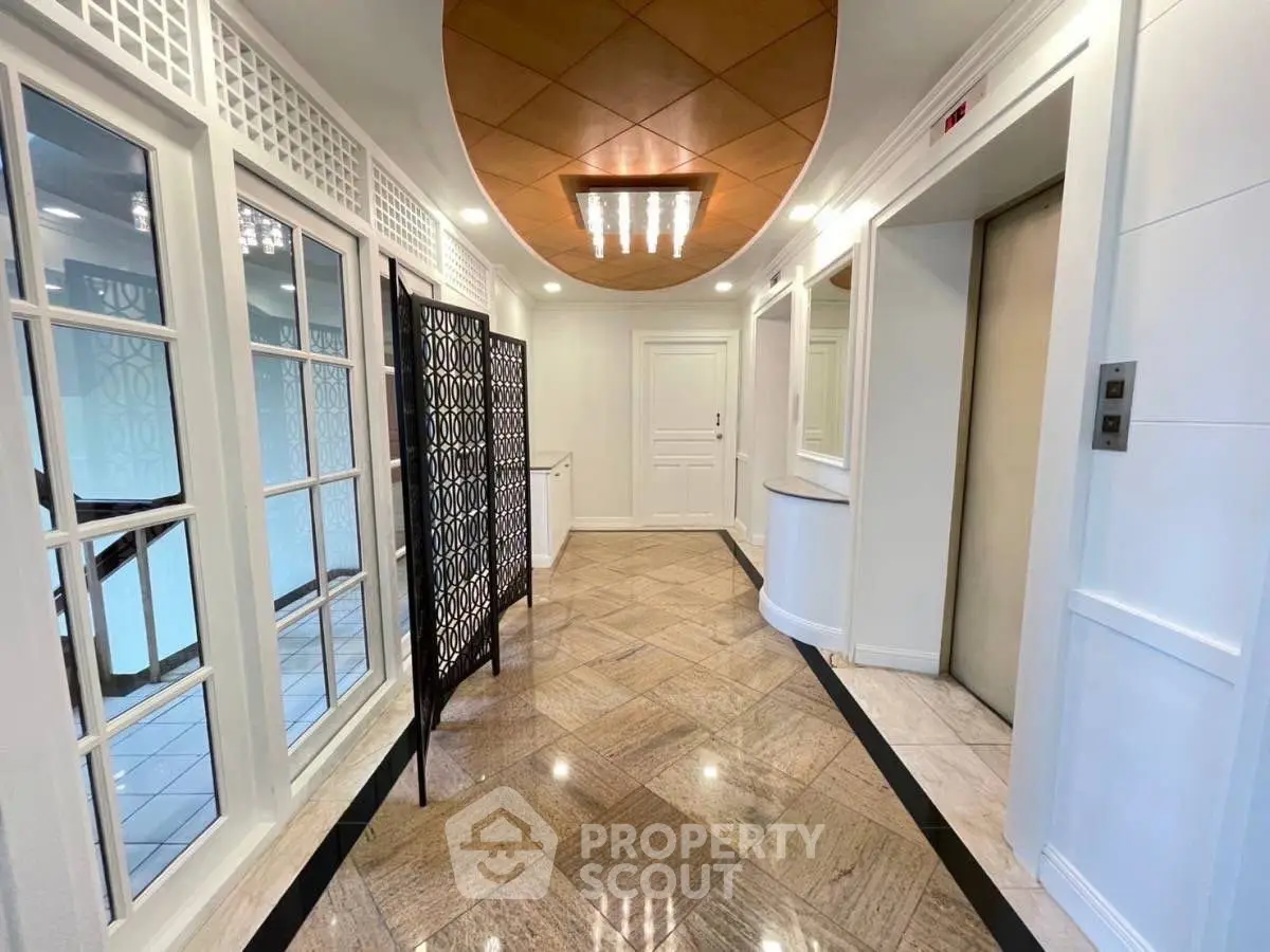 Elegant building entrance with modern elevators and stylish decor