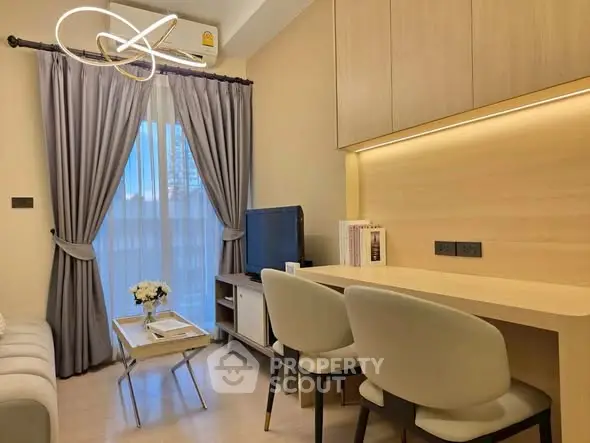 Modern living room with elegant decor and natural light, featuring a cozy seating area and stylish furniture.