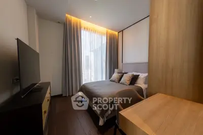 Modern bedroom with large window and stylish furnishings in a luxury apartment.