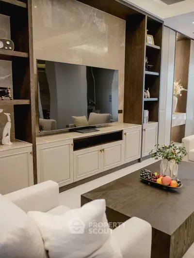 Luxurious living room with modern decor and large flat-screen TV