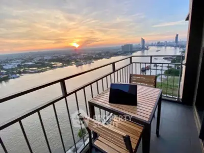 Stunning river view from high-rise balcony at sunset, perfect for relaxation and cityscape admiration.