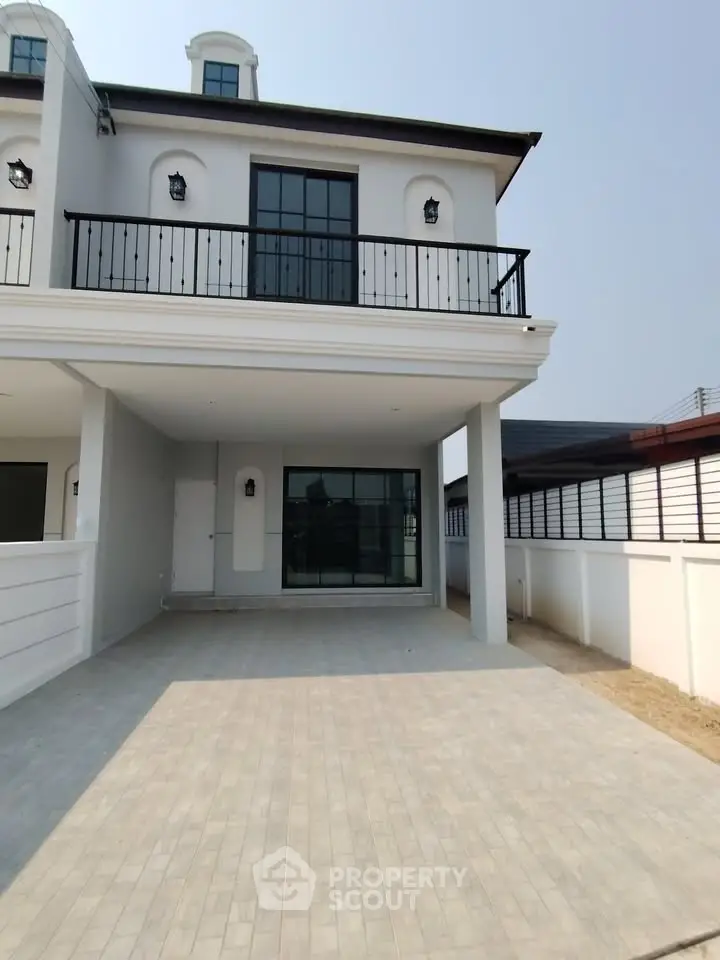 Elegant modern townhouse with spacious driveway and stylish balcony, perfect for urban living.