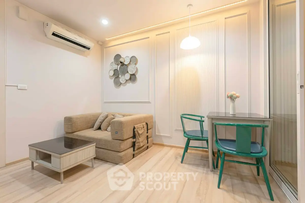 Modern living room with cozy sofa, stylish decor, and dining area in elegant apartment.