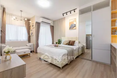 Modern bedroom with stylish decor, featuring a cozy bed, elegant lighting, and ample storage space.