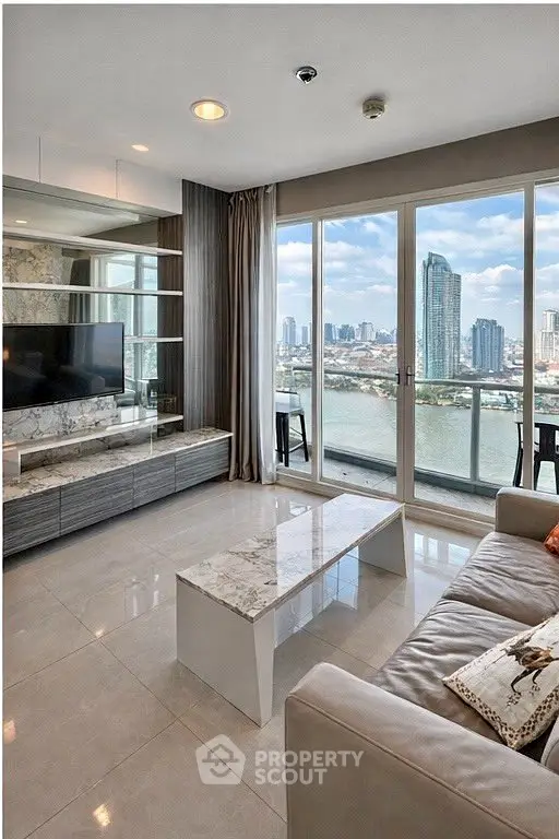 Luxurious living room with stunning river view and modern decor in high-rise apartment.
