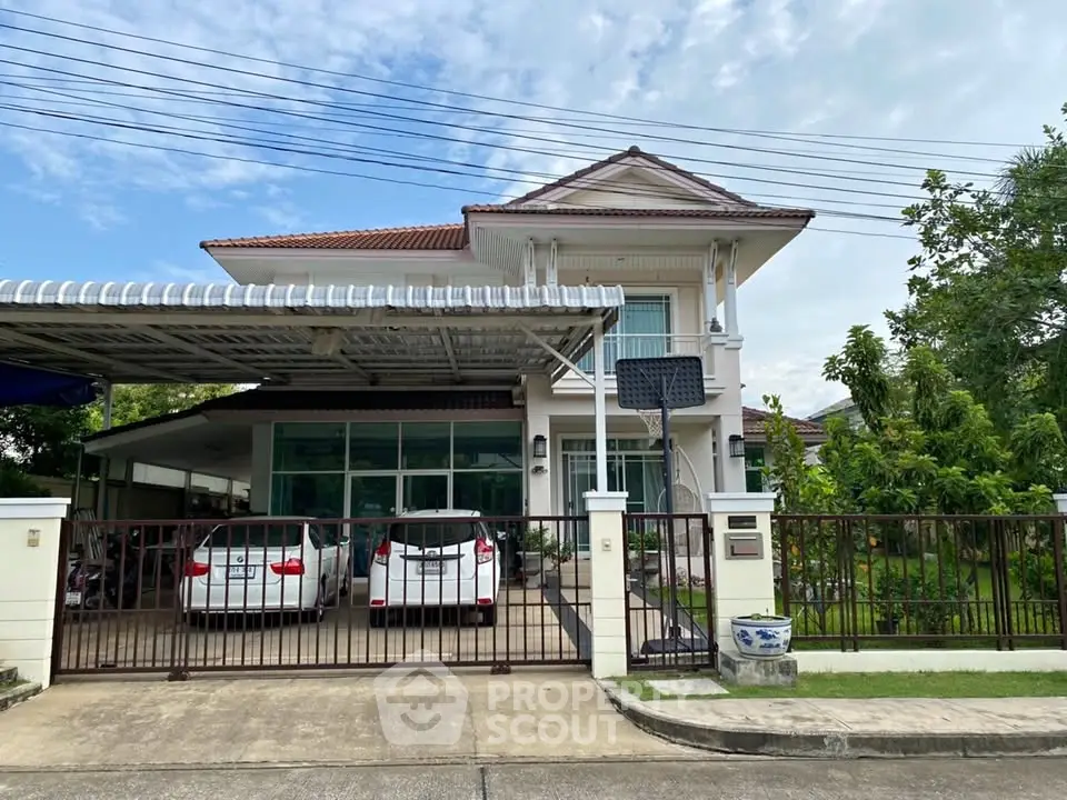 Charming two-story house with spacious driveway and lush garden, perfect for family living.