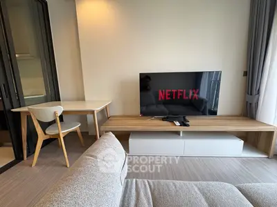 Modern living room with stylish furniture and large TV, perfect for entertainment and relaxation.