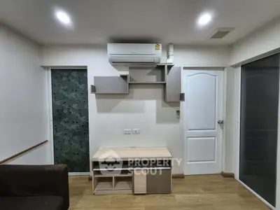 Modern living room with sleek air conditioning and stylish shelving unit.