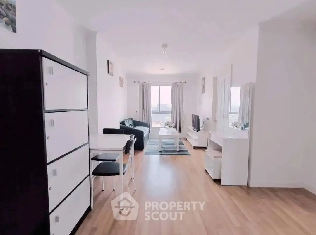 Spacious modern living room with wooden flooring and natural light