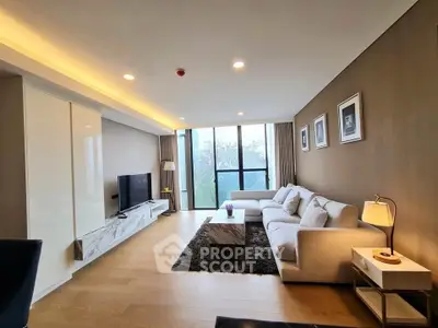 Spacious modern living room with large windows and elegant decor