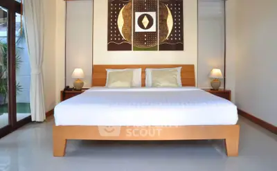 Elegant bedroom with modern decor and large windows for natural light.