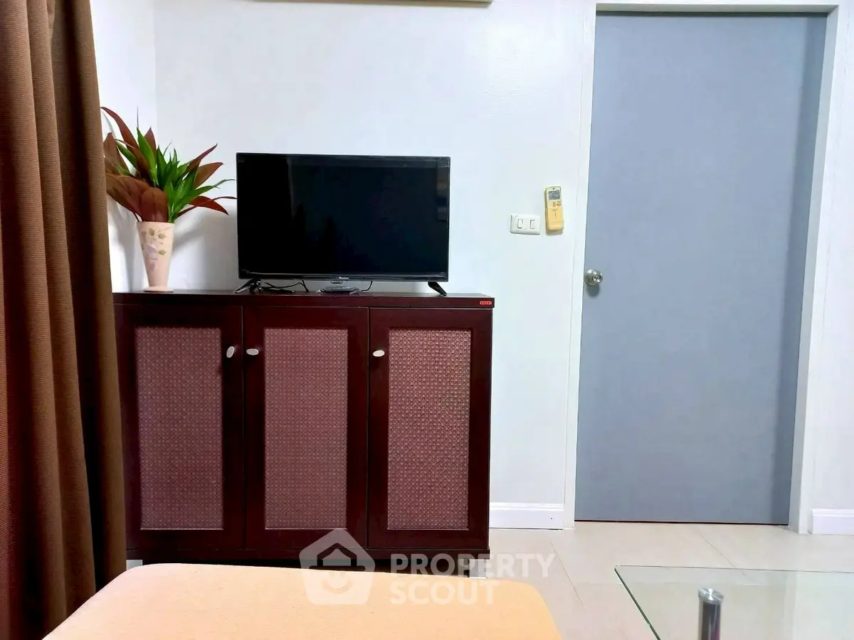 Cozy living room with modern TV setup and stylish cabinet