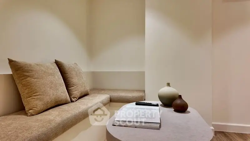 Cozy minimalist living room with built-in seating and stylish decor.