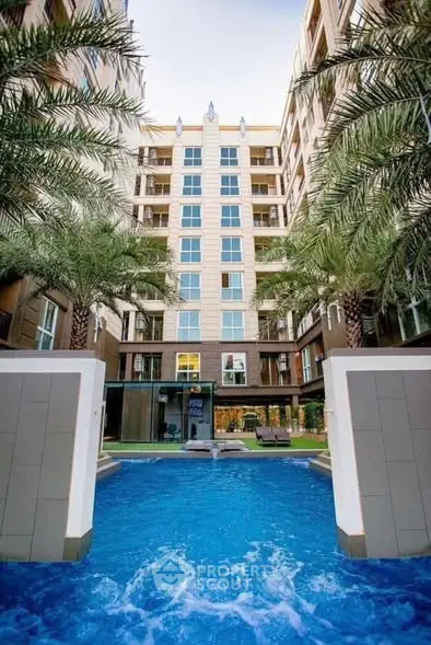 Luxurious apartment building with stunning pool and palm trees