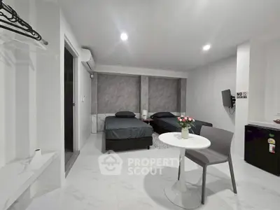 Modern minimalist bedroom with twin beds and sleek decor