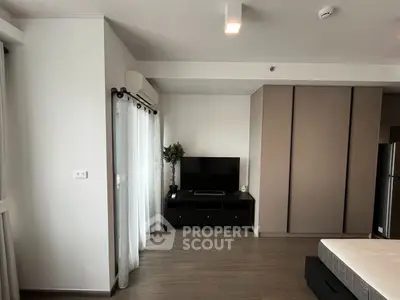 Modern bedroom with sleek TV setup and minimalist decor