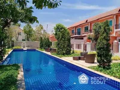 Stunning residential complex with a luxurious outdoor pool and lush greenery.