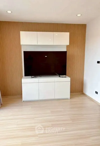 Modern living room with sleek TV unit and wooden accent wall