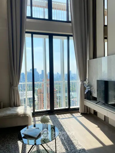 Luxurious living room with floor-to-ceiling windows and stunning city view
