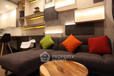 Modern living room with stylish furniture and vibrant cushions in a contemporary apartment.