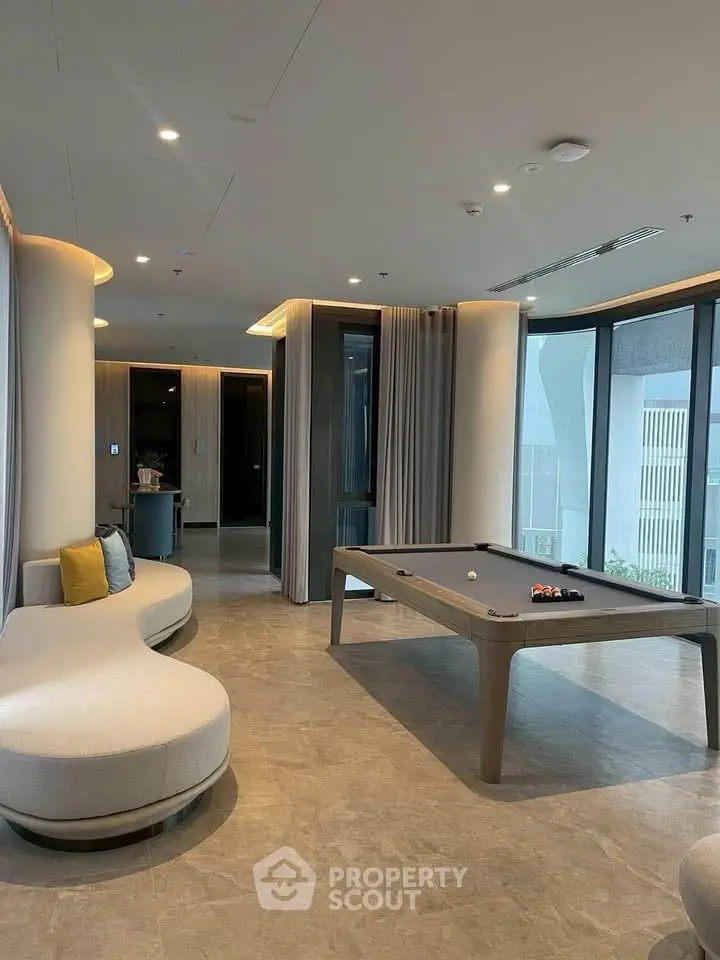 Luxurious modern living space with pool table and stylish seating, perfect for entertainment and relaxation.
