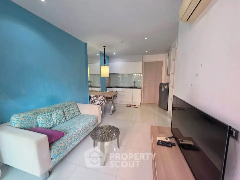 Modern living room with stylish decor and open kitchen layout in a contemporary apartment.