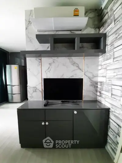 Modern living room with sleek TV cabinet and marble accent wall
