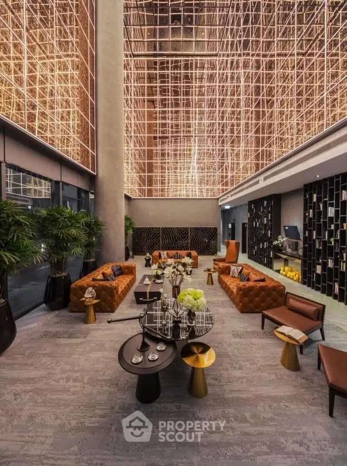Luxurious modern lobby with stunning ceiling design and elegant seating area.