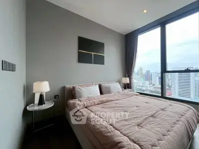 Modern bedroom with city view, featuring large windows and stylish decor in a high-rise apartment.