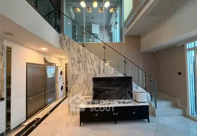Luxurious modern duplex with marble staircase and sleek kitchen appliances