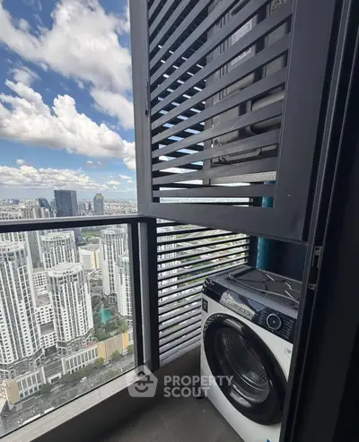 High-rise apartment balcony with washing machine and stunning city view.