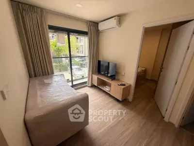 Cozy living room with modern decor and natural light in a stylish apartment.