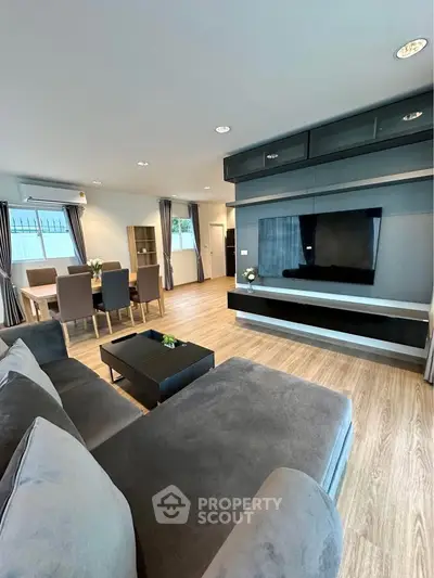 Spacious modern living room with sleek furniture and dining area