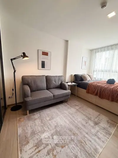 Modern bedroom with cozy sofa and stylish decor