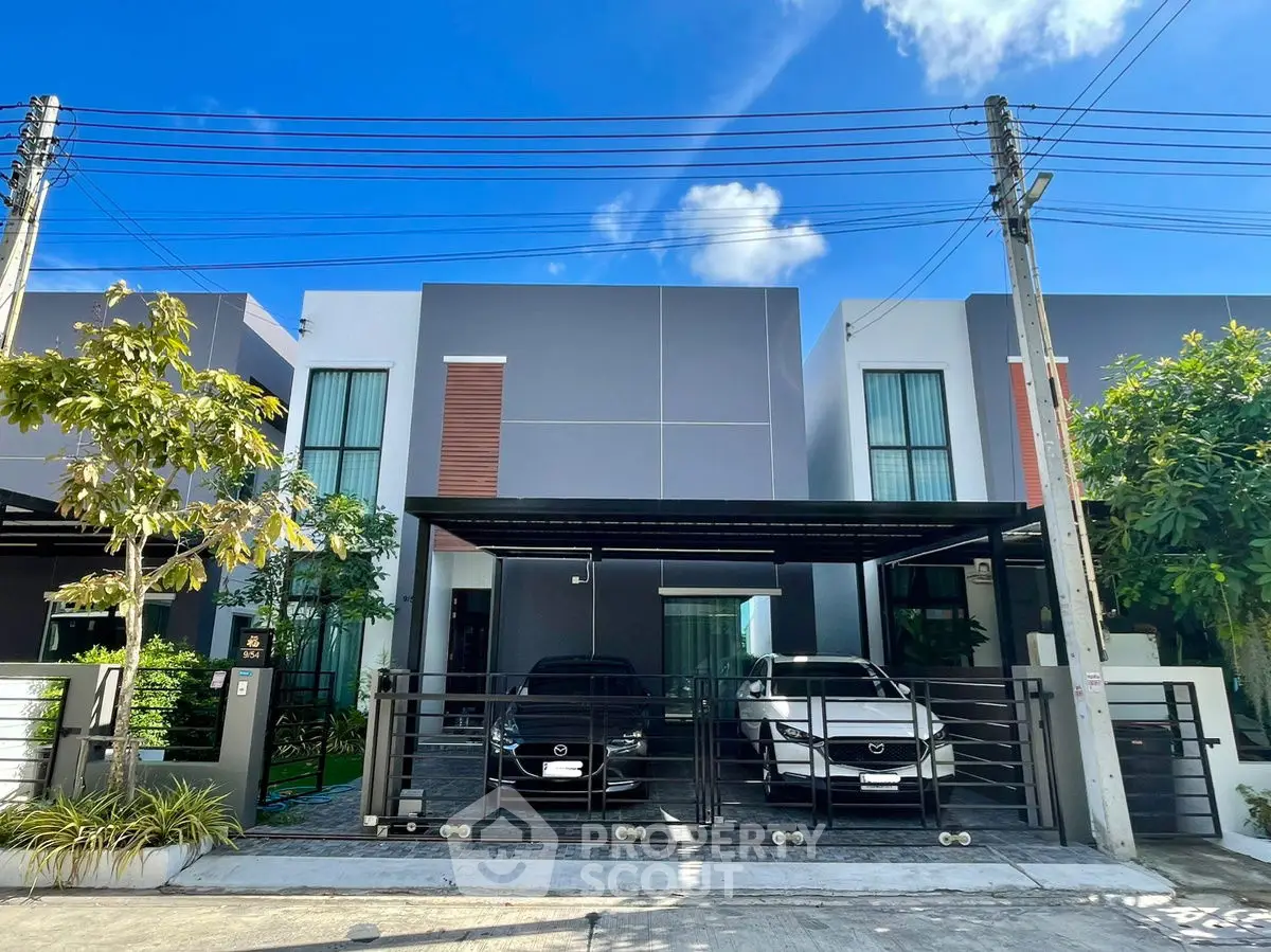 Modern townhouse exterior with two-car garage and sleek design.