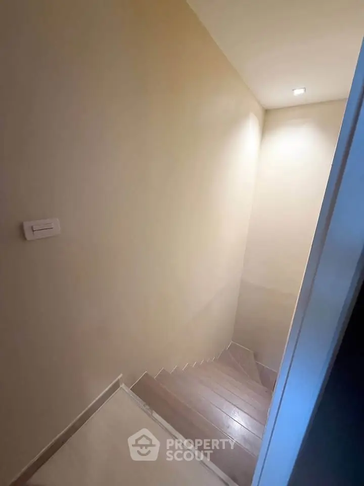 Modern staircase with sleek wooden steps and minimalist design in a contemporary home.