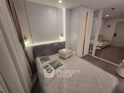 Modern bedroom with stylish lighting and cozy decor in a contemporary apartment.