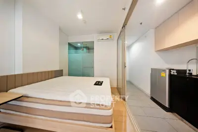 Modern studio apartment with sleek design and compact kitchen area