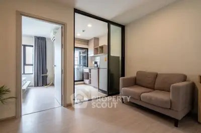 Modern apartment interior with cozy living room and sleek kitchen design.