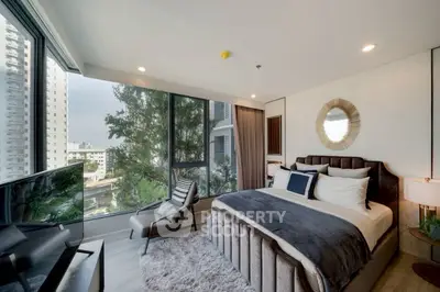 Luxurious bedroom with floor-to-ceiling windows and city view