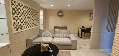 Spacious living room with modern decor and elegant dining area