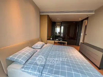 Spacious modern bedroom with stylish decor and ample natural light