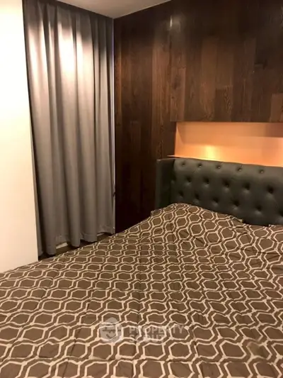 Cozy modern bedroom with stylish wood paneling and elegant bedding