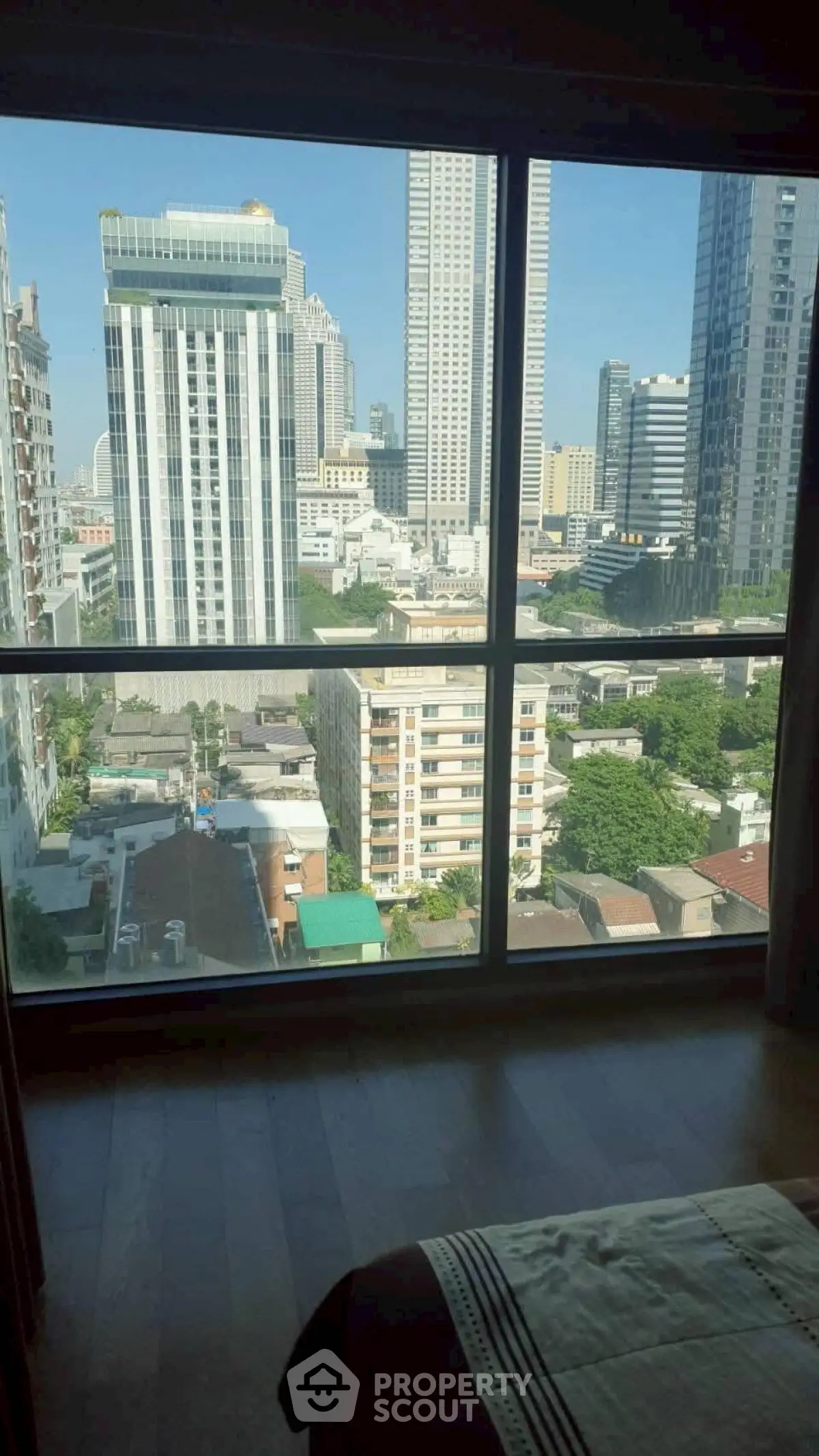 Stunning cityscape view from a high-rise apartment window, showcasing urban living at its finest.
