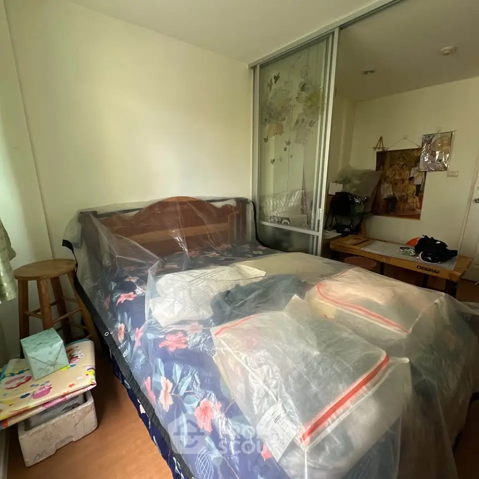 Cozy bedroom with wooden bed and sliding closet doors, perfect for a restful retreat.