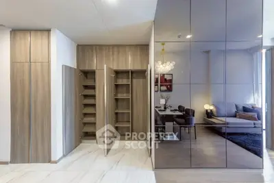 Modern open-concept living and dining area with sleek storage solutions and elegant decor.