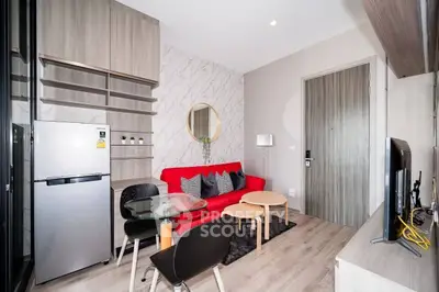 Modern living room with red sofa, stylish decor, and compact dining area