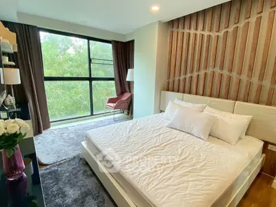 Luxurious bedroom with large window and stylish decor in modern apartment