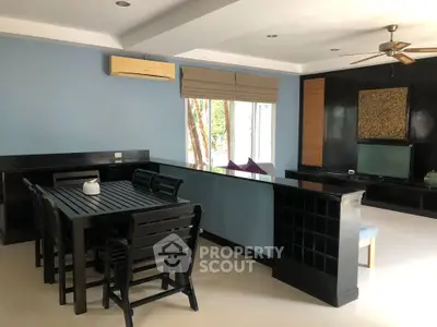 Spacious living room with modern dining set and entertainment area
