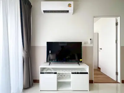 Modern living room with sleek TV stand and air conditioning, perfect for cozy relaxation.